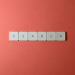 White keyboard keys spelling 'search' on a bold red surface, conceptual design with copyspace.